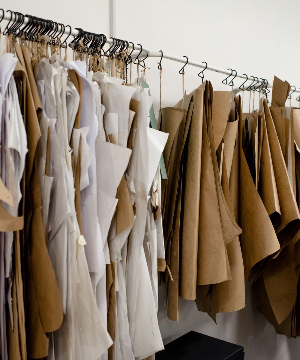 A rail of linen and camel garments in the atelier