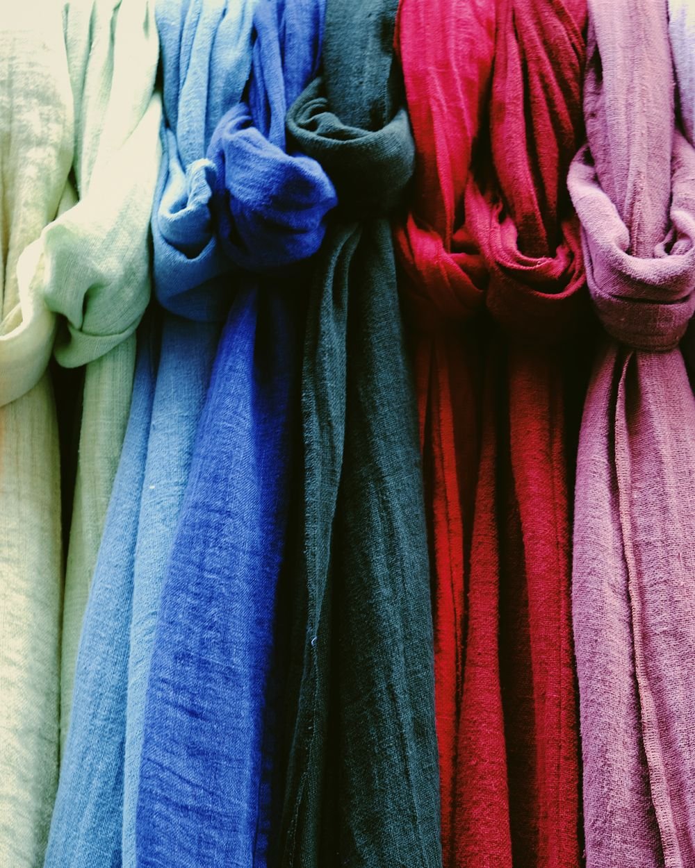 Rolls of coloured fabric in the studio